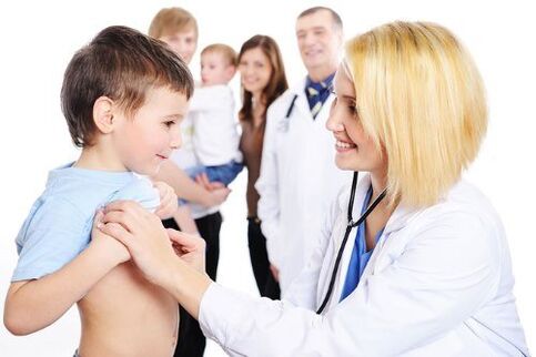 the doctor examines a child with worms
